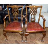 Pair of mahogany Georgian style open arm chairs, each with undulating top-rail above Gothic