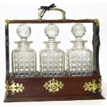 Tantalus oak frame containing three cut glass decanters. Condition reports are not available for our