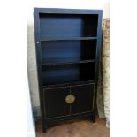 Black lacquered bookcase. Condition reports are not available for our Interiors Sale.