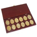 Cased set of 12 oval silver gilt medallions depicting the arms of the Prince and Princess of Wales