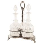 3 cut glass decanters on a silver plated tri-form stand , the 3 round bottle decanters complete with