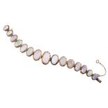 Opal set silver line bracelet , the cabachon cut stones graduating between 8 x 6mm and 16 x 10mm,