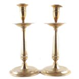 A pair of 19th century brass candlesticks of 17th century design, each with tulip shaped socket