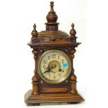 Small Victorian 8-day mantel clock with turned finials and stepped decoration to top. Condition