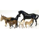 Three Beswick donkeys, a fawn, a Royal Doulton black beauty and foal (Condition: chip to one hoof of