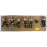 Six un-boxed Britains Football figures with black/white verticle stripes, black shorts and black