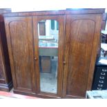 Victorian mahogany triple wardrobe with mirrored central door, 177cm wide. Condition reports are not