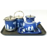 Wedgwood Jasperware to include a teapot, tray, two biscuit barrels, also one other unmarked barrel