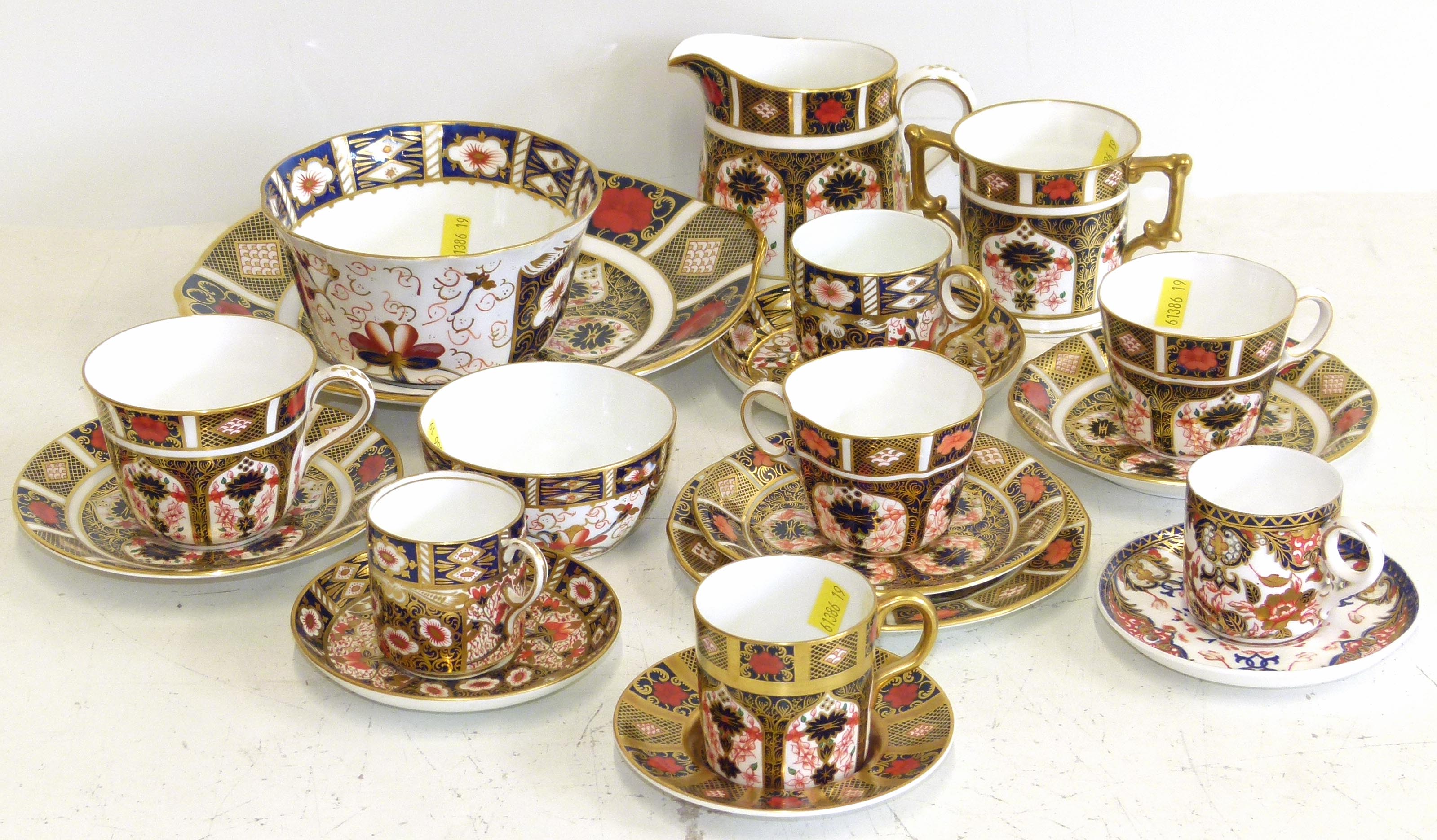 A collection of Royal Crown Derby teaware to include two bowls, a cake plate, a trio of cups and