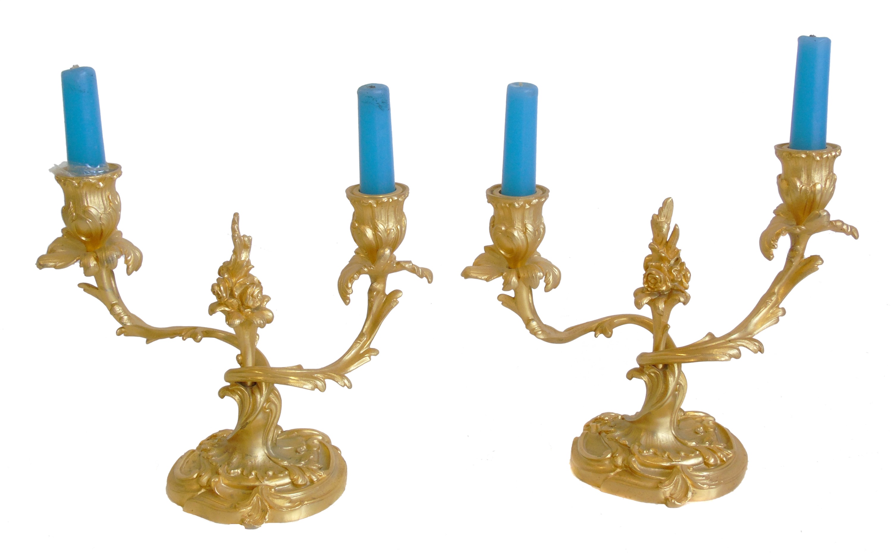 A Pair of late 19th century gilded metal Rococo design two branch table candlesticks.