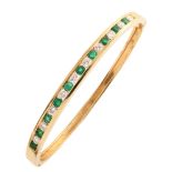 Diamond and emerald set 18ct yellow gold bangle