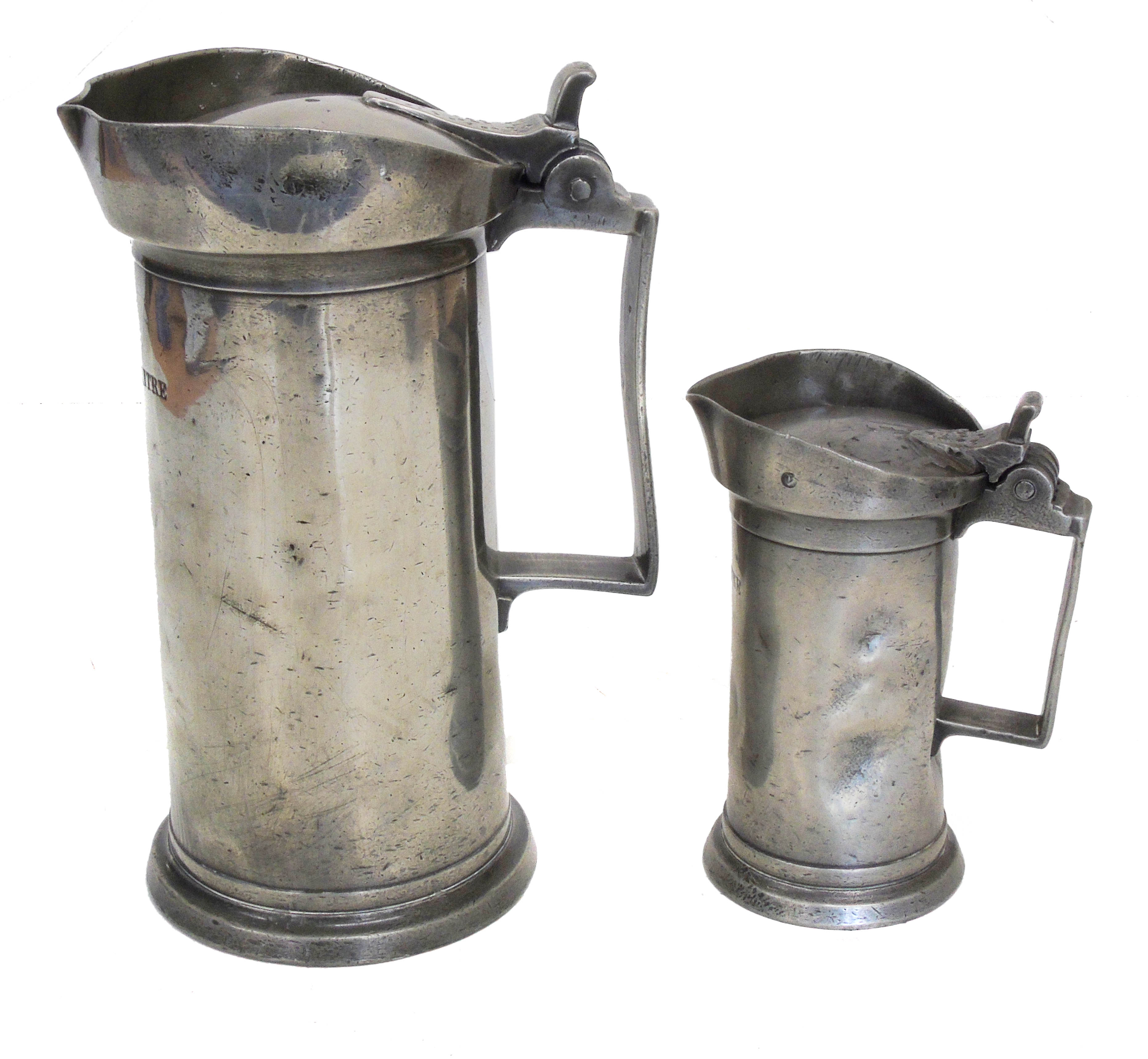 Two 19th century Continental pewter cylinder shaped measures.