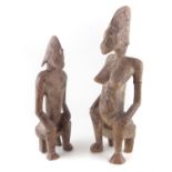 Two African Senufo figures of a seated male and seated female