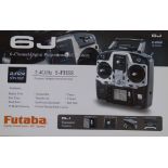 Futaba 6J-2.4GHZ transmitter and manual complete with seven receivers.