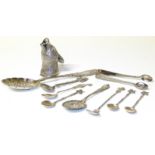 An assortment of silver items including three teaspoons, a bottle top in the form of a foxes head,
