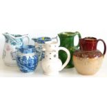 Six early 19th century jugs, including a puzzle jug, husbandmans jug etc. Condition reports are