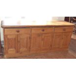 Victorian pine kitchen dresser base enclosing three double cupboards and three drawers 212cm wide,