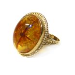 A 9ct gold amber (Clarified) dress ring Condition reports are not available for Interiors Sale