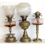 Victorian embossed brass oil lamp and two others. Condition reports are not available for