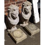 A pair of pre-cast ornamental lions on plinths 75cm tall excluding plinth Condition reports are