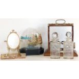 Edwardian oak two bottle tantalus, Victorian model boat under dome and small brass swing mirror on