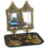 Pair of embossed brass wall mirrors (lacking sconces), brass door knocker, set of four brass clock