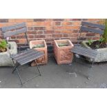 A pair of terracotta coloured planters and a pair of folding garden chairs Condition reports are not