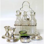 Silver plated six part cruet set, two small silver weighted candle holders, silver salt with blue