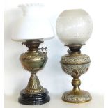 Two Victorian embossed brass oil lamps. Condition reports are not available for the Interiors