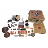 A collection of early 20th century gramophone needle boxes along with three record cleaning pads.