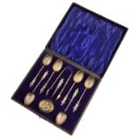 Boxed set of six silver apostle spoons, tongs and strainer.