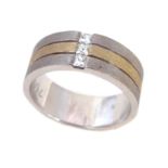 A diamond three stone set 18ct white and yellow gold three section band ring.