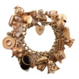 9ct gold charm bracelet containing 24 assorted gold charms.