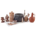 Collection of pottery antiquities and script fragment.