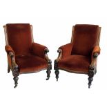 A pair of Victorian sprung upholstered armchairs.