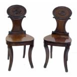 Pair of Regency mahogany hall chairs.