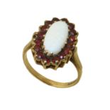 A 9ct gold opal and garnet cluster ring, the oval opal cabochon within a circular shape garnet
