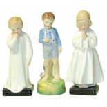 Three Royal Doulton figures "Bedtime", "Darling", and "She Loves Me Not". Condition reports are