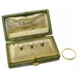 A band ring and cased seed pearl dress studs, gross weight 4.2g. Condition reports are not available