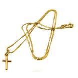 A cross pendant, suspended from a fancy link chain, stamped 750, chain with Italian assay marks,