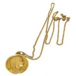 A 18ct gold Christening medal, of circular outline, depicting Mary and signed Grun, suspended from a
