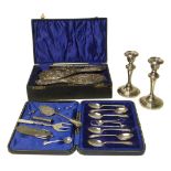 A selection of silver items to include a cased set of teaspoons, silver filled candle sticks, silver
