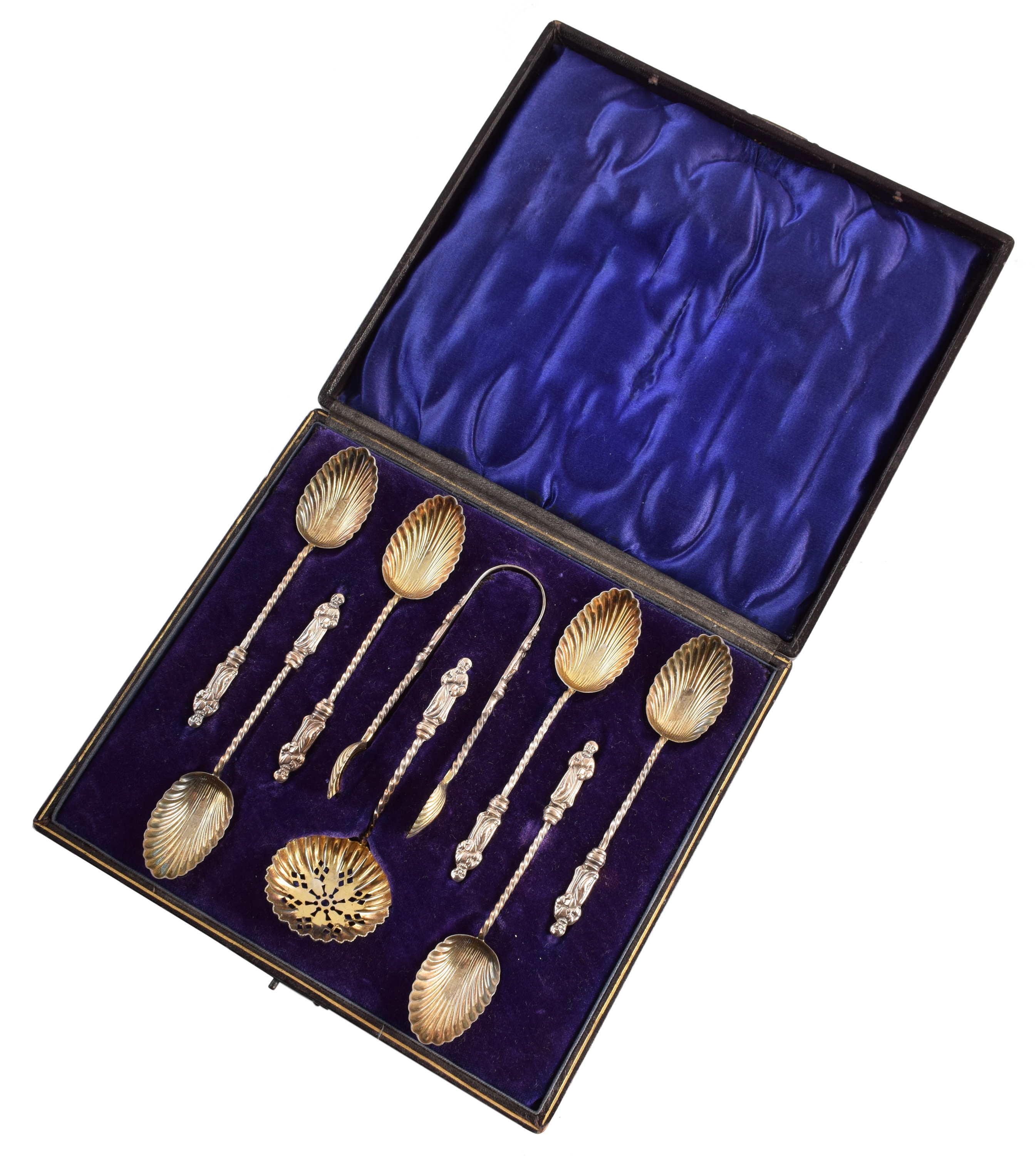 Boxed set of six silver apostle spoons, tongs and strainer.