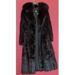 A black fur coat, the three quarter length black fur coat with tapered lapels. Condition reports are