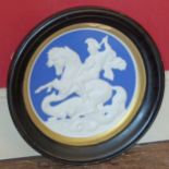 Circular ceramic plaque depicting Romanesque horse-rider slaying a Dragon. Condition reports are not