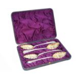 A cased set of four George III silver berry spoons,