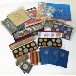 A box with various sets of British coins and a collection of East Africa Ten Cents.