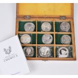 Box containing seven USA Dollar coins and two silver Chinese 1oz Panda coins.