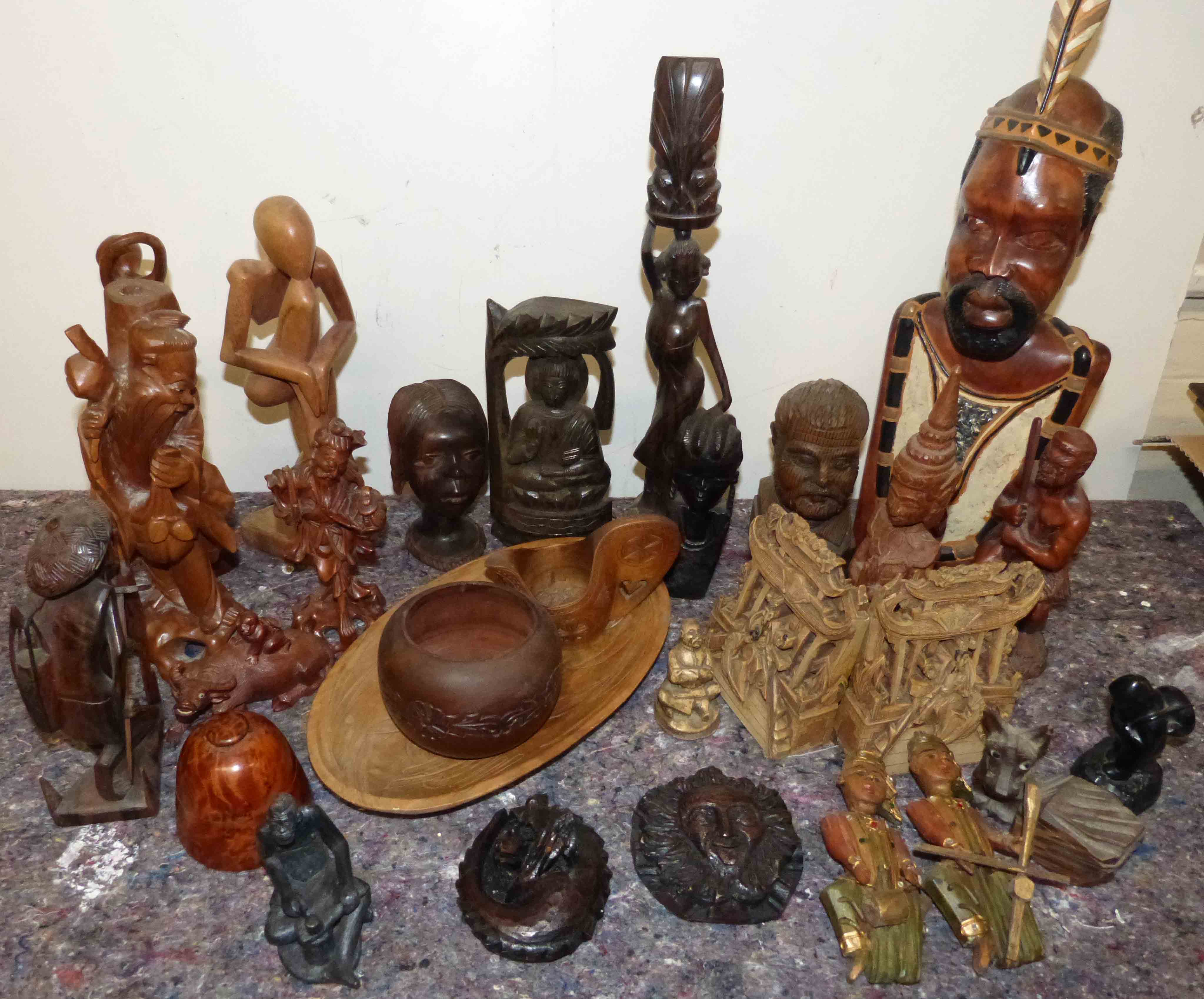 A quantity of mixed African and Asian figures, containers and book ends etc Condition reports not