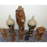 A pair of modern cherub column candle holders and six continental carved figures Condition reports